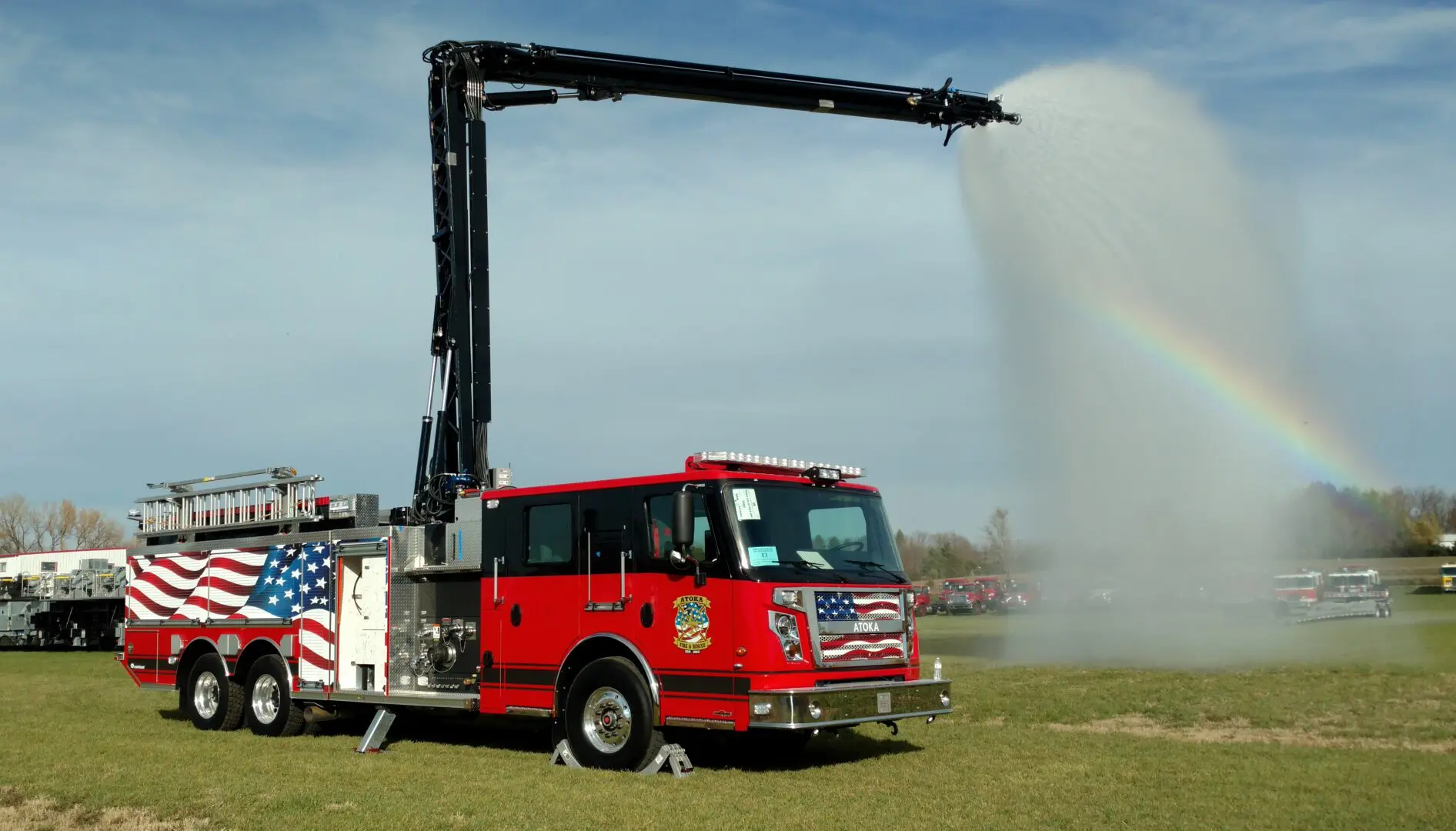 A Fire Truck With a Jet of Spraying Water at a Side