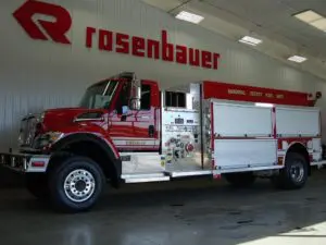 Fire truck parked in a shelter with Rosenbauer logo on the wall