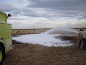 Men spraying water from a fire truck